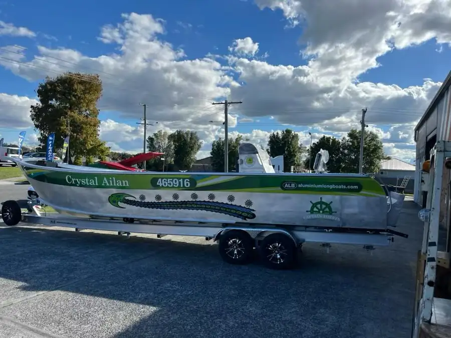 The Crystal Ailan branded collection vessel on its trailer, marked with the company name and registration.